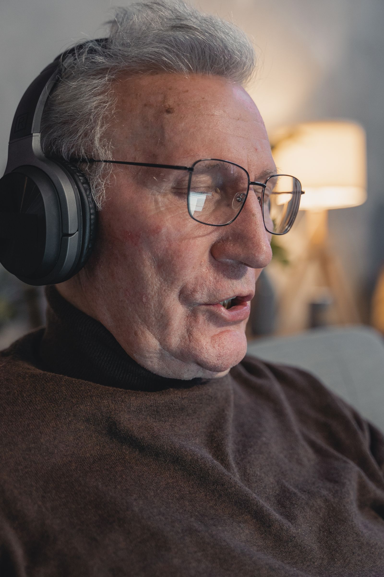 Older man wearing headphones during a hearing assessment